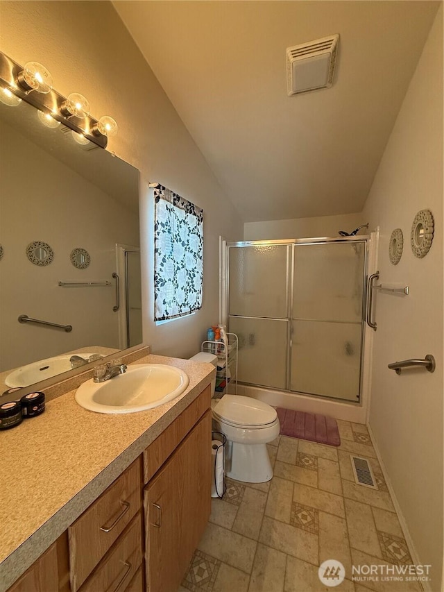 bathroom with visible vents, vaulted ceiling, vanity, and toilet