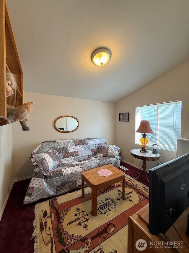 living room featuring lofted ceiling and baseboards