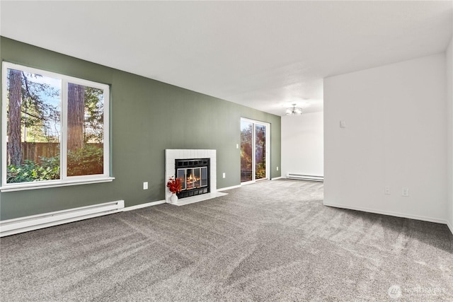 unfurnished living room with carpet, a baseboard radiator, baseboard heating, a fireplace with flush hearth, and baseboards