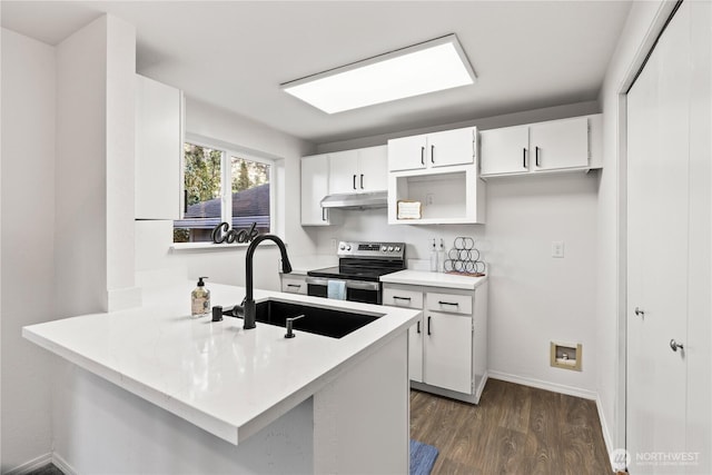 kitchen with under cabinet range hood, a peninsula, a sink, stainless steel range with electric cooktop, and dark wood-style floors