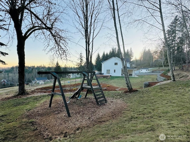 playground at dusk featuring a yard