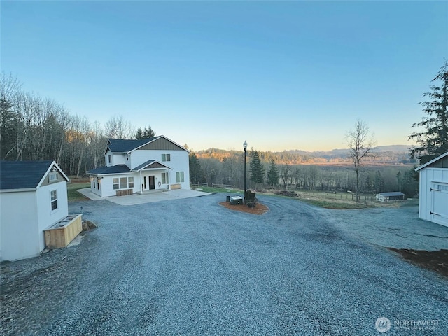 view of street with gravel driveway