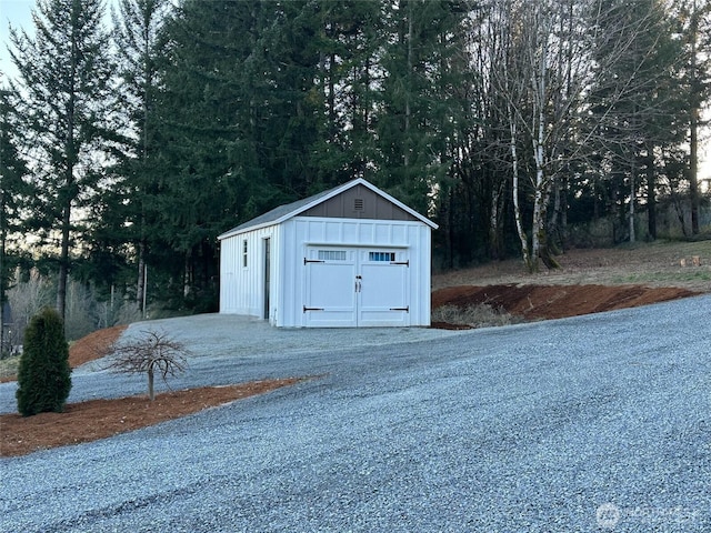 view of shed featuring gravel driveway