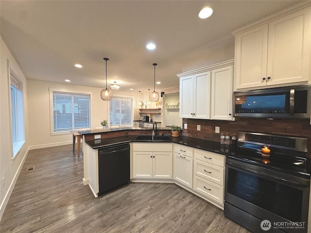 kitchen featuring dark wood-style flooring, a sink, dishwasher, a peninsula, and stainless steel electric range