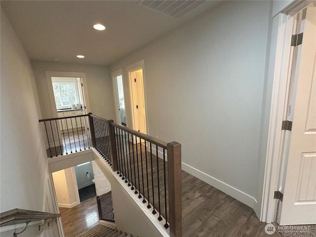 staircase with baseboards, visible vents, wood finished floors, and recessed lighting