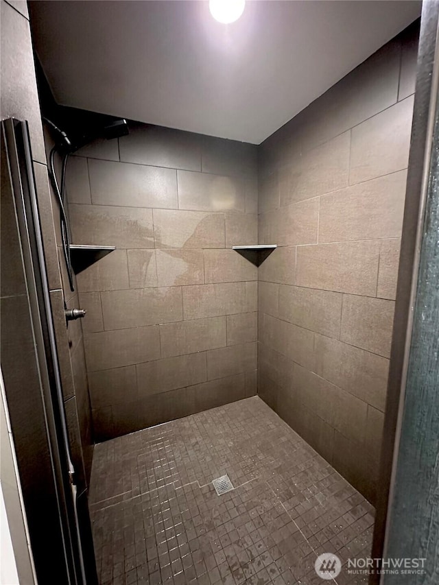 bathroom with a tile shower