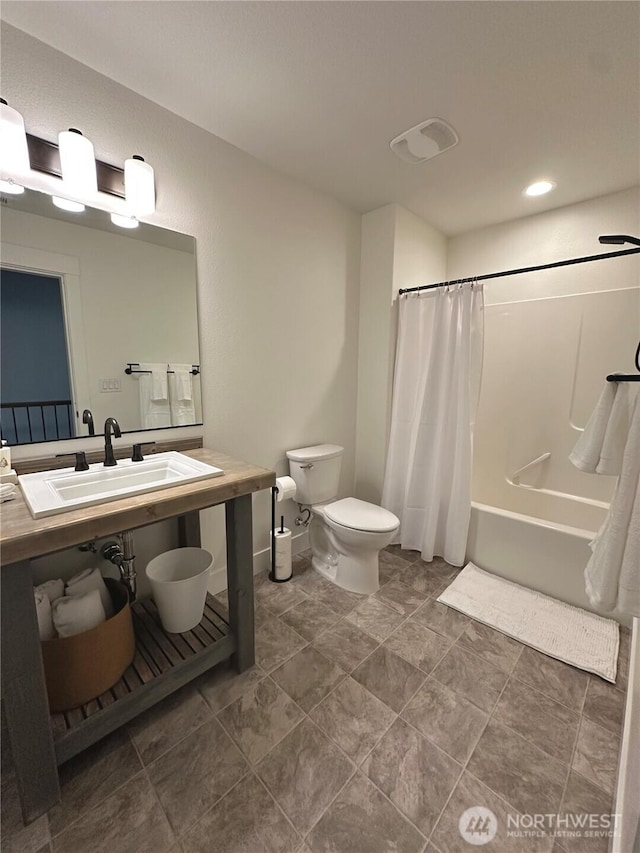 bathroom featuring shower / tub combo, a sink, and toilet