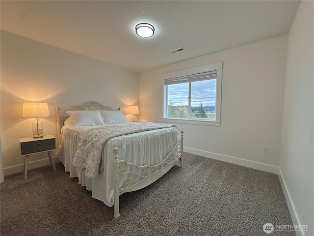 carpeted bedroom featuring visible vents and baseboards