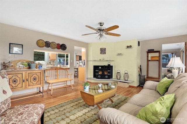 living room with a ceiling fan and wood finished floors