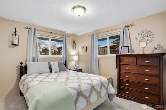 carpeted bedroom with baseboards and a textured ceiling