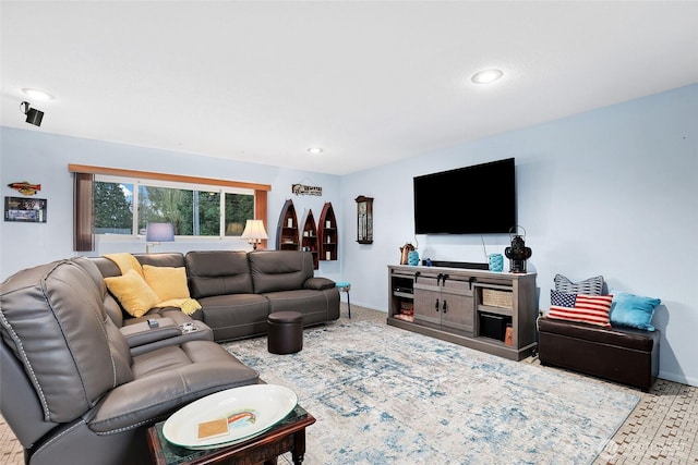 living area featuring baseboards and recessed lighting