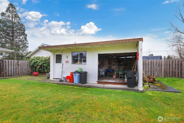 exterior space featuring an outbuilding and a fenced backyard