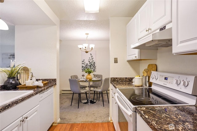 kitchen with light wood-style floors, white cabinets, a textured ceiling, white appliances, and under cabinet range hood