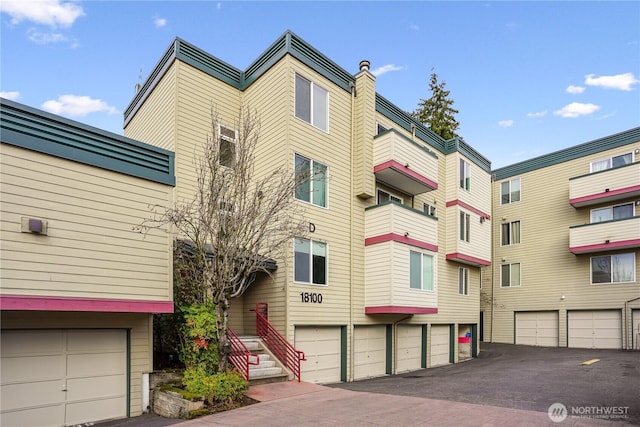 view of building exterior with community garages