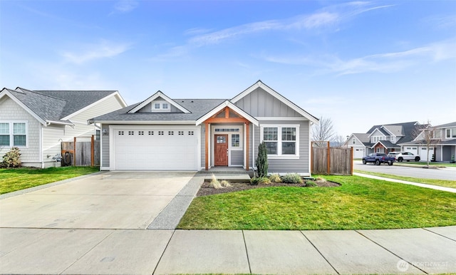 view of front of property featuring concrete driveway, board and batten siding, a front yard, fence, and a residential view