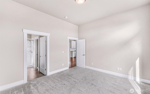 unfurnished bedroom featuring carpet floors and baseboards