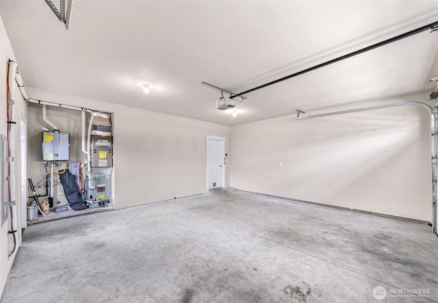 garage featuring heating unit, tankless water heater, and a garage door opener