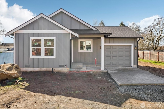 view of front of house with a shingled roof, fence, board and batten siding, and crawl space