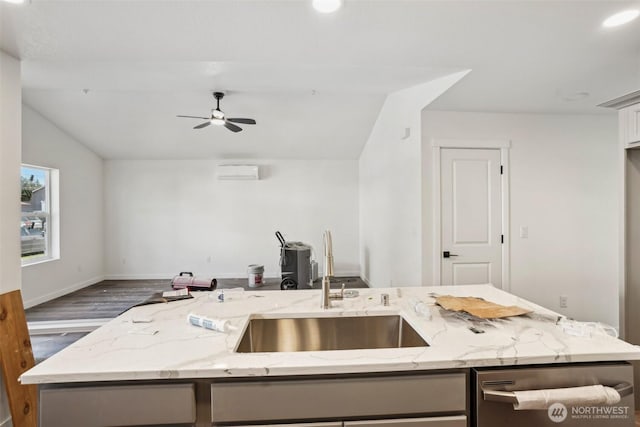 kitchen featuring open floor plan, dishwasher, lofted ceiling, a ceiling fan, and a sink