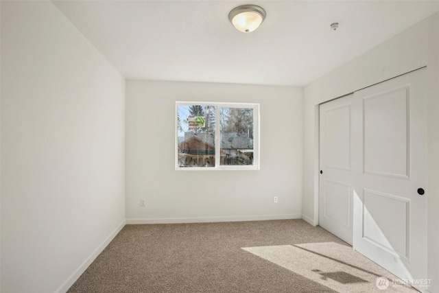 unfurnished bedroom with baseboards and carpet floors