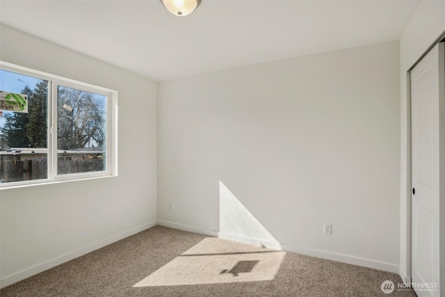 unfurnished bedroom featuring carpet flooring and baseboards