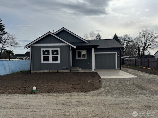 ranch-style house with concrete driveway, a garage, fence, and board and batten siding