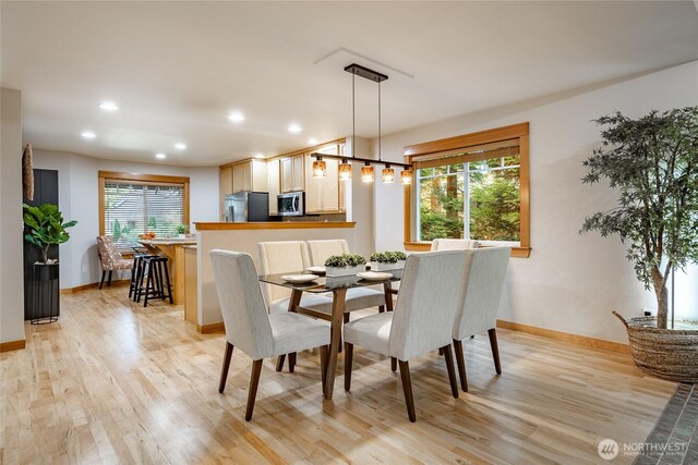 dining space featuring baseboards, recessed lighting, and light wood-style floors