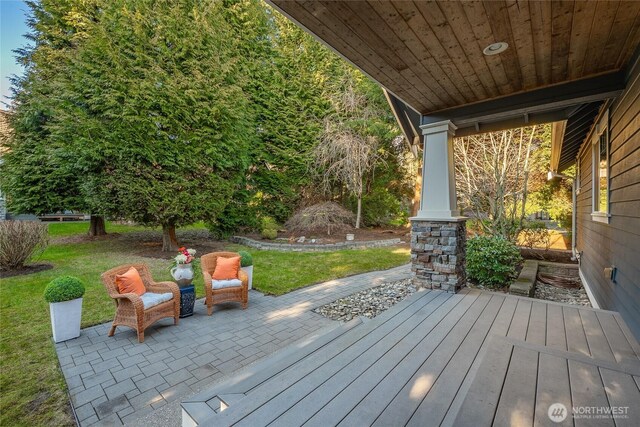 wooden deck featuring a lawn