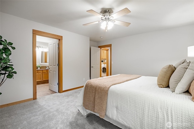 bedroom with washer / clothes dryer, light carpet, ceiling fan, and baseboards