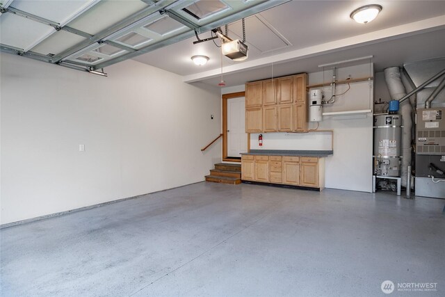 garage featuring a garage door opener and strapped water heater