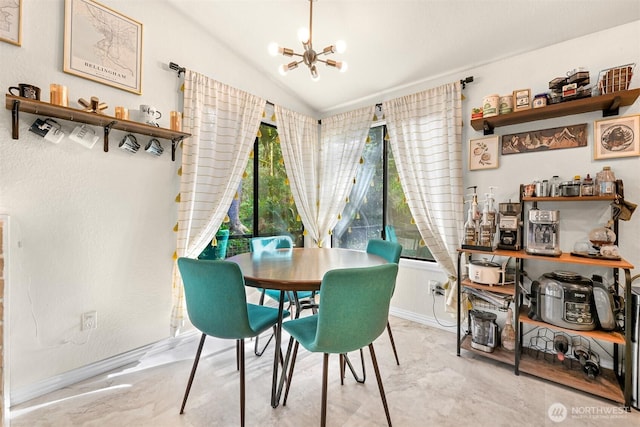 dining space with a notable chandelier, marble finish floor, baseboards, and lofted ceiling