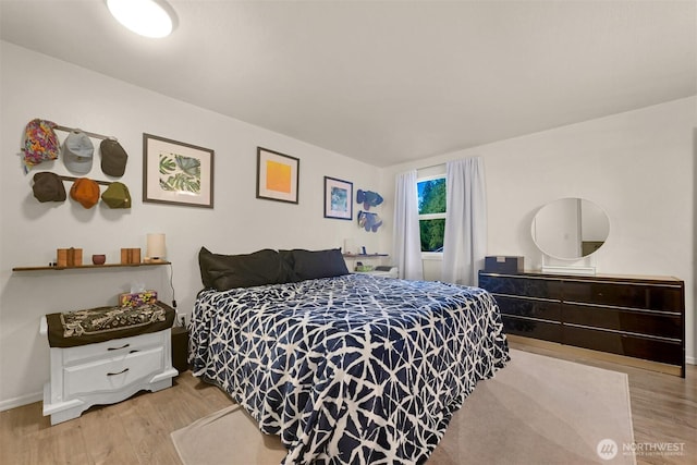 bedroom featuring baseboards and light wood-style flooring