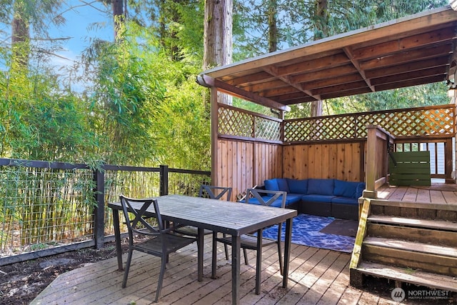 wooden deck with an outdoor hangout area and outdoor dining space