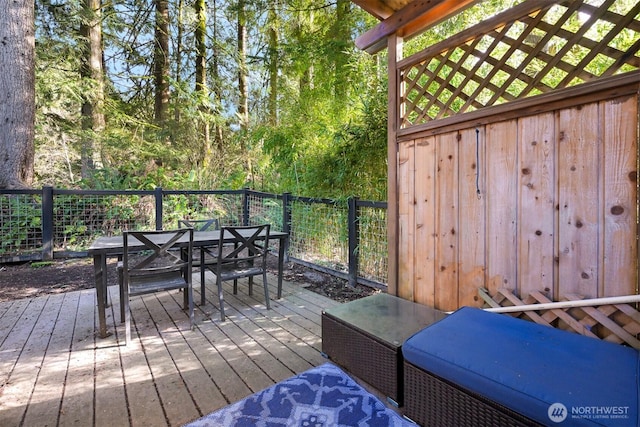 wooden terrace featuring outdoor dining area