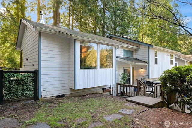 back of property featuring crawl space and a deck