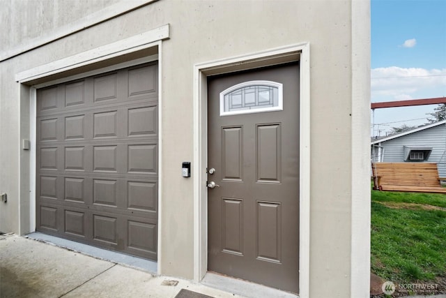 doorway to property featuring stucco siding