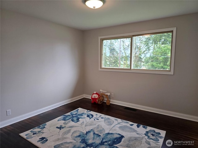 bedroom with visible vents, baseboards, and dark wood-style flooring