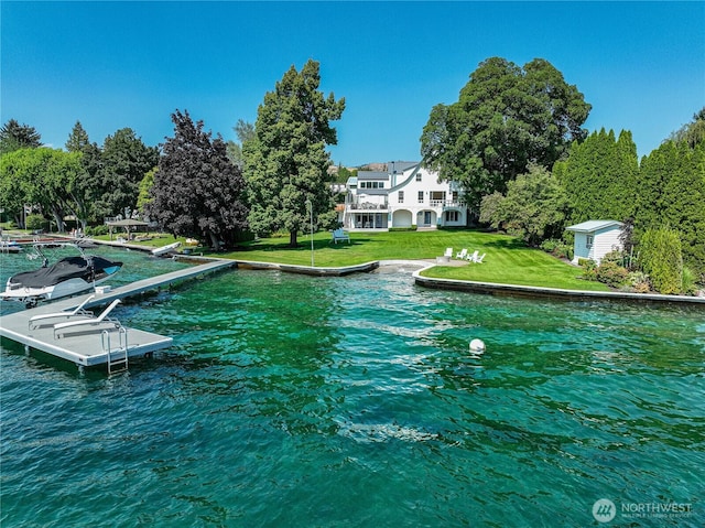 exterior space with a lawn and a water view