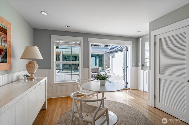 foyer with recessed lighting, a wainscoted wall, and light wood-style floors