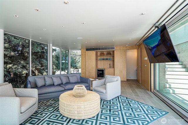 living area with a wall of windows, wine cooler, light tile patterned floors, and recessed lighting