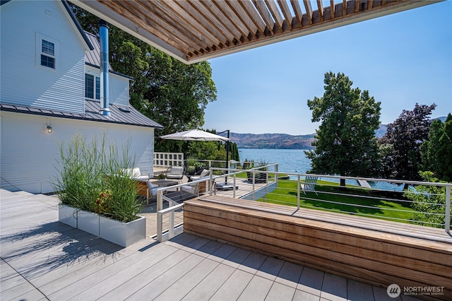 wooden terrace with a water and mountain view