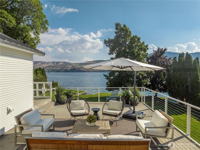 deck with an outdoor hangout area and a water and mountain view