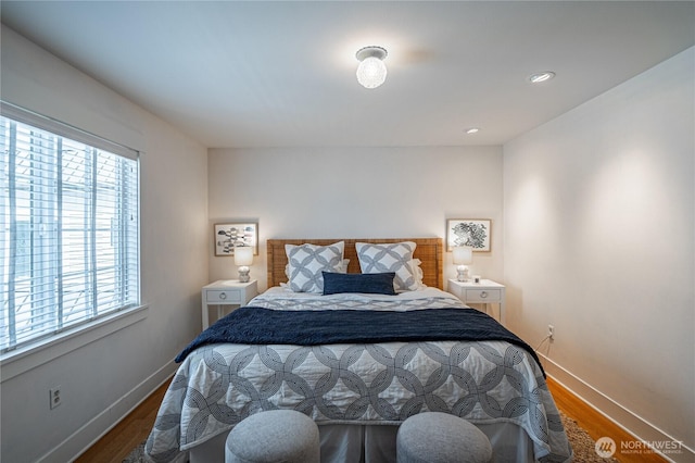 bedroom with wood finished floors and baseboards