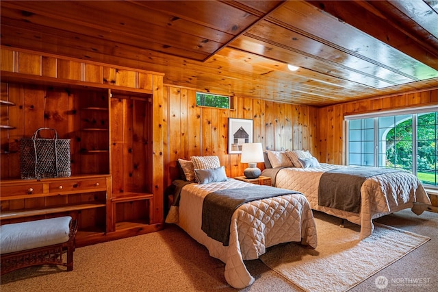 bedroom with wood ceiling, carpet, and wood walls