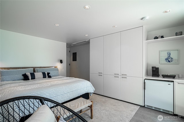 bedroom featuring fridge, a closet, electric panel, and recessed lighting