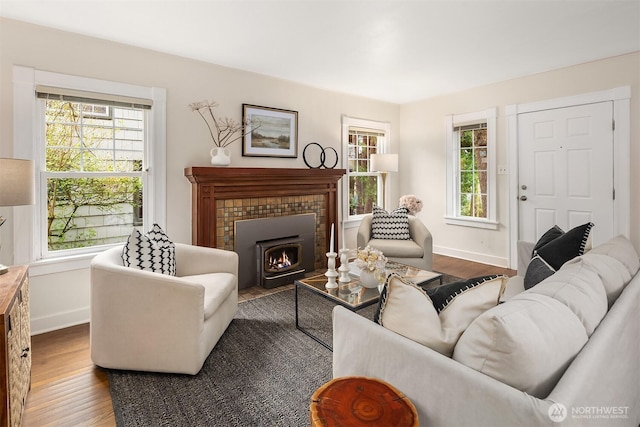 living area featuring baseboards and wood finished floors