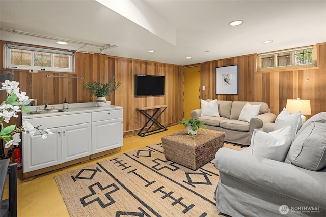 living room featuring recessed lighting and wood walls