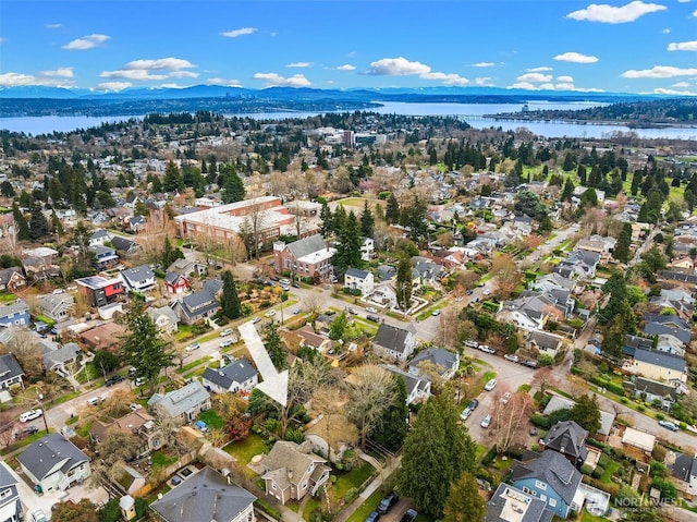 birds eye view of property with a water and mountain view