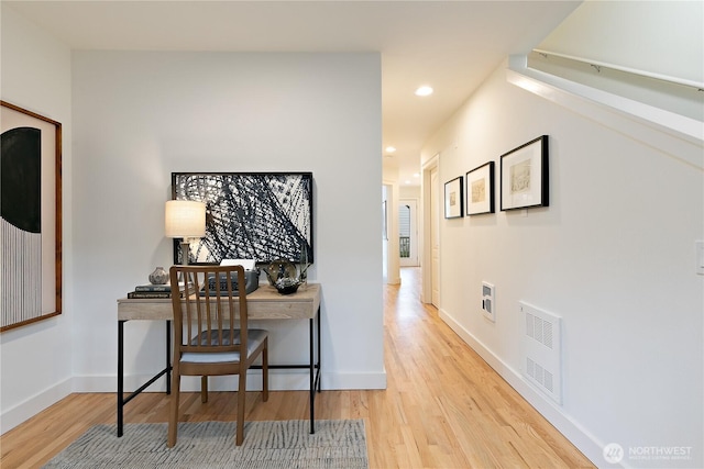 office featuring recessed lighting, visible vents, baseboards, and wood finished floors