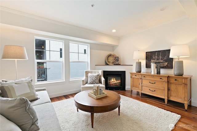 sitting room with baseboards, ornamental molding, and dark wood-style flooring